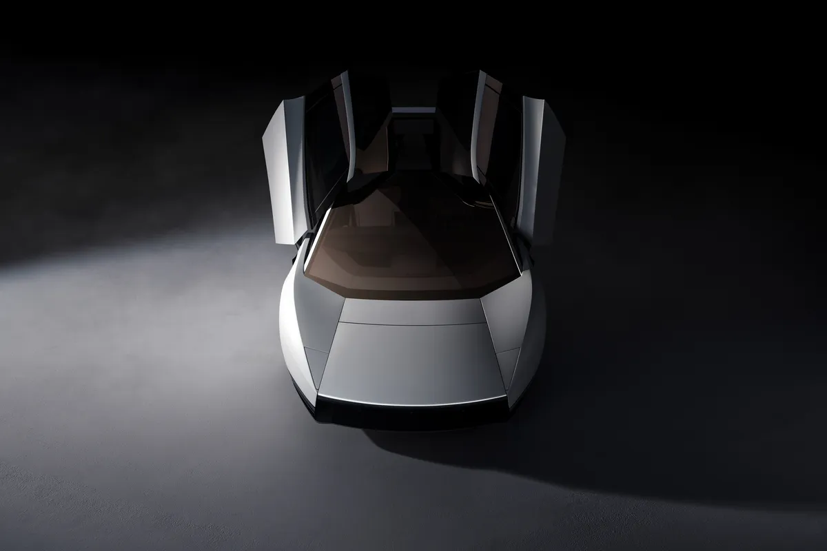 Silberner Tesla Roadster aus erhöhter Frontperspektive mit beiden aufgestellten Türen und sichtbarem dunklem Innenraum.